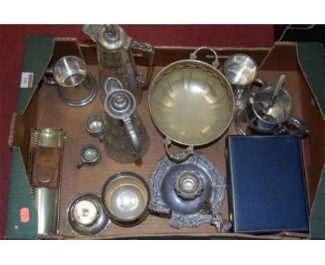 Box of silver plated items to include two glass claret jugs, chamber stick etc