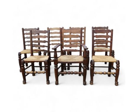 A set of seven ash ladder back chairs - with shaped rails, some with seagrass seats, on turned legs joined by peripheral stre