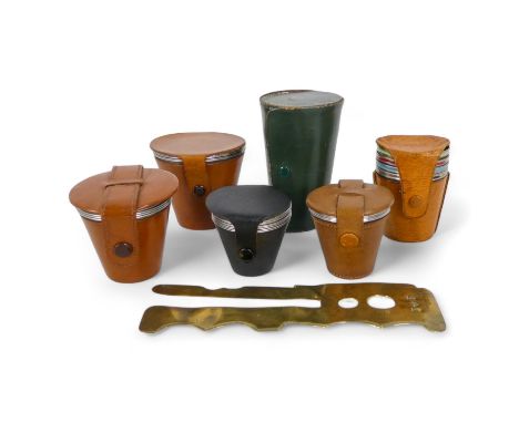A set of four stainless steel travel beakers - in a pig skin holder, together with five other groups of cups and a brass butt