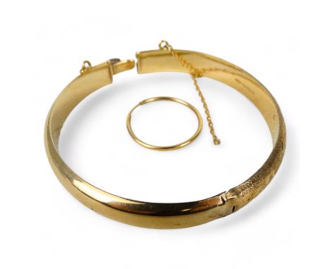 A 9ct gold bangle - hinged with a clasp, engraved with flowers and foliage, together with a single 9ct hoop earring, 11.1g.