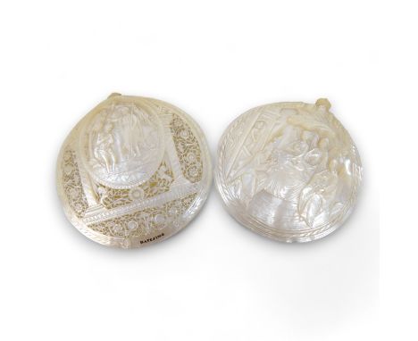 Two Jerusalem carved mother of pearl religious shell tokens - pierced and decorated with Christian iconography, 14cm high.