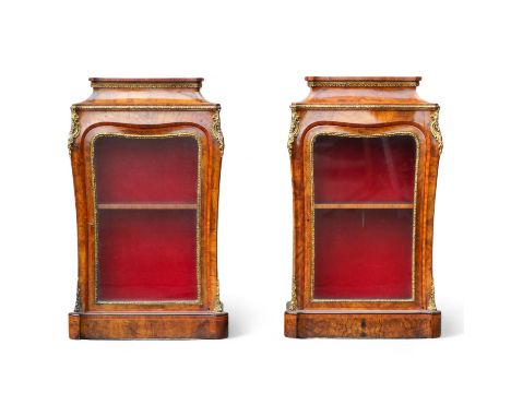 A pair of Victorian walnut, tulipwood banded and gilt metal mounted display cabinets - with caddy moulded tops above shaped a