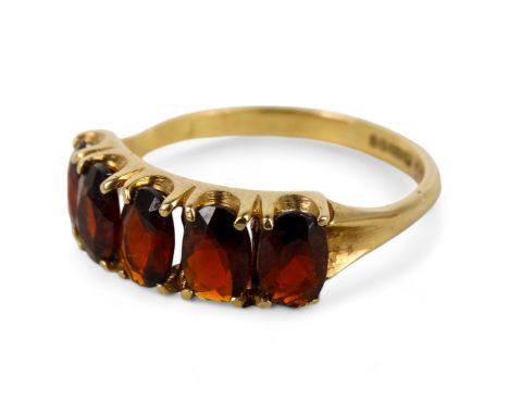 A 9ct gold five stone garnet ring - claw set with oval cut stones, size R, 2.6g.