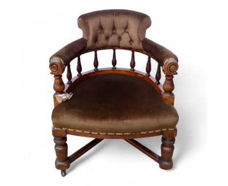 An Edwardian walnut Captain's chair - button upholstered in brown fabric, the horseshoe shaped back with turned supports abov