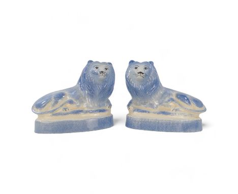 A pair of Rye Pottery lions - recumbent, with a blue sponged finish, 18cm wide. (2)