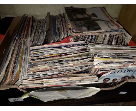 A box containing approx 250 singles. Various genres and artisies including Status Quo, Tenpole Tudor, Bryan Ferry, Fiction Fa