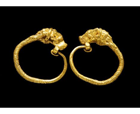 Greek Gold Earrings with Head of Antelope, 4th Century BC.Delicate earrings consisting of a circlet of gold wire, twisted ban