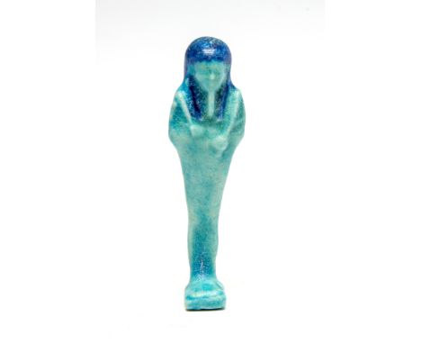 Egyptian Bichrome Glazed Faience Shabti FigurePtolemaic Period, C. 300 BC.A vibrant ushabti in dark and light blue faience. S