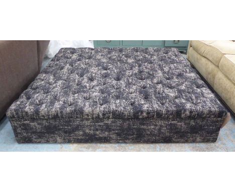 FOOTSTOOL/POUFFE, of large proportions, in a buttoned black speckled fabric, 155cm x 155cm x 33cm H.