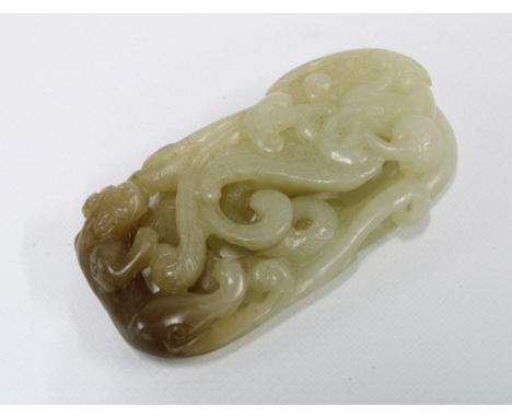 Carved jade plaque with a panther and scrolling foliage, 6 x 3cm 