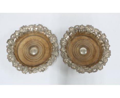 A pair of Sheffield plate wine coasters, Henry Wilkinson, with turned wood bases and fruit and vine pattern, 18cm (2) 