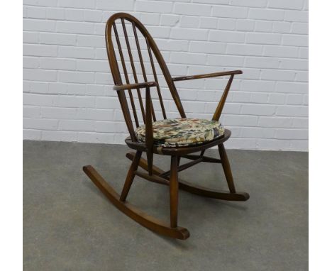 Ercol dark elm rocking chair with loose floral cushion 