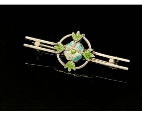 An Arts and Crafts silver and enamelled brooch, circa 1910, the central four petal flower with blue tipped white enamel petal