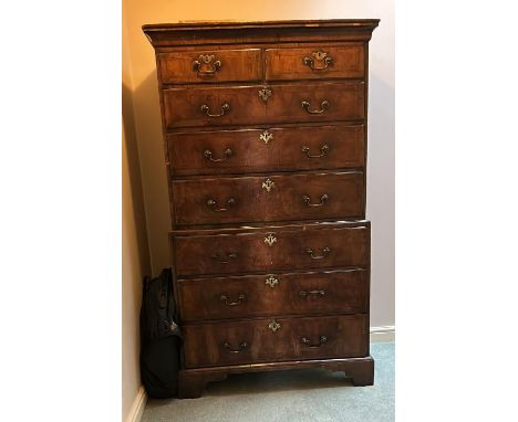 A George II walnut chest on chest, circa 1730, plain cornice, feather banded front with two short over three long drawers to 