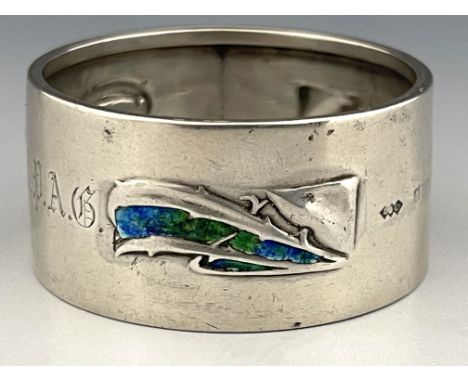 Archibald Knox for Liberty and Co., an Arts and Crafts silver and enamelled napkin ring, Birmingham 1906, embossed with styli