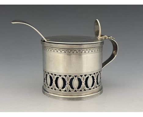 A George III silver mustard pot, Henry Chawner, London 1789, reticulated and bright cut drum form, with plat lid engraved wit