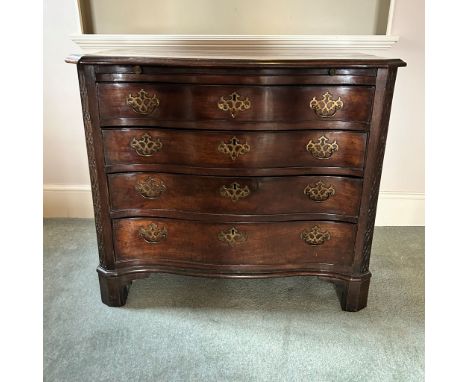 An early George III mahogany serpentine chest of drawers, circa 1770, ogee moulded top over a brushing slide, four long gradu