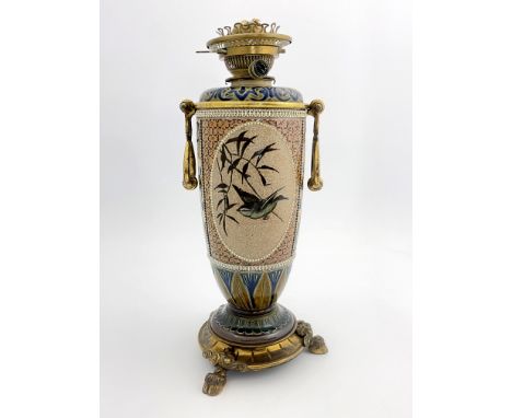 Florence Barlow for Doulton Lambeth, a stoneware oil lamp, 1883, footed ovoid form, decorated with oval panels of pate sur pa