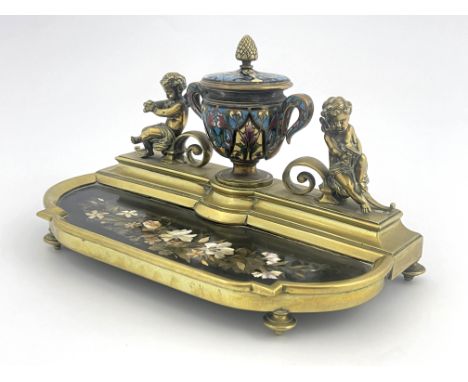A late 19th Century brass desk inkstand, champleve enamel twin handled ink vessel with brass pineapple finial flanked by wing