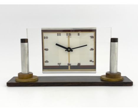 Leon-Hotot for ATO, an Art Deco chrome and maccassar clock, the plain glass rectangular face flanked by column supports on sl