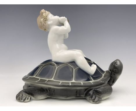 Ferdinand Liebermann for Rosenthal, a porcelain figure of a boy playing the pan pipes on a tortoise, model K.320, highlighted