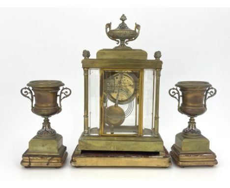 A French brass clock garniture, circa 1870, the breakfront case of Baroque architectural form with urn and pineapple finials,