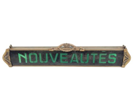 Ren Herbst for Siegel, an Art Nouveau French hanging shop sign, 'Nouveautes', 'A' form metal frame fitted with an opaque gree