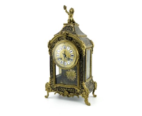 A 19th century French Boulle work mantel clock, arched form with cast putti surmount the embossed brass dial with porcelain i