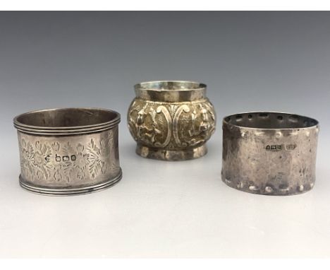 An Arts and Crafts silver napkin ring, Albert Edward Bonner, London 1912, planished, embossed with dot and baton borders, tog