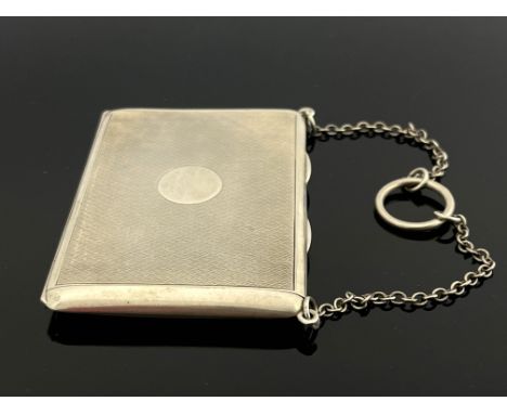 A George V silver card case, Sampson Mordan and Co., London 1919, engine turned purse form, with sprung hinged lid and washed