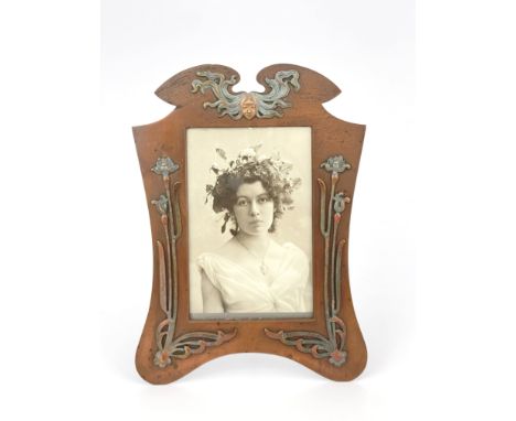An Austrian cold painted photograph frame, circa 1900, in the Art Nouveau style, bracket form with winged pediment, applied m