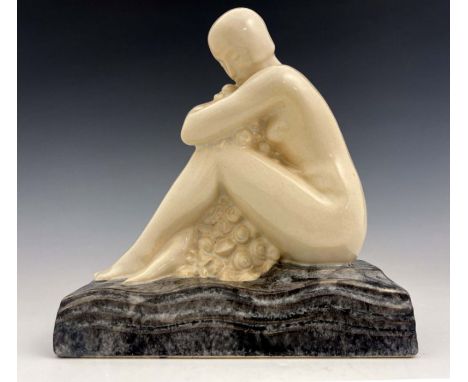 L Rossat for Marcel Guillard, an Art Deco ceramic figure of a nude woman, circa 1930, modelled sitting embracing flowers, on 