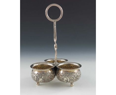 An Edwardian silver cruet stand, Jacob Fenigstein, London 1910, three conjoined cauldron form vessels united with a central t