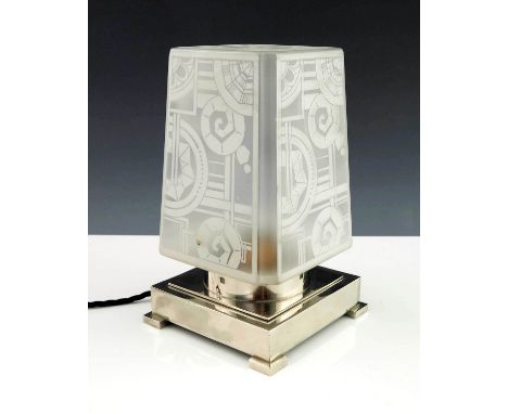 A French Art Deco table lamp with geometric frosted glass shade on chromed circular collar and square base, with four block f