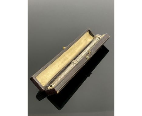 A silver propelling pencil, engine turned, slide action, set with a bloodstone seal top, in fitted case, 9cm long