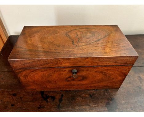 A George III rosewood tea caddy, circa 1810, of rectangular form, the hinged cover opening to a fitted interior with twin lif