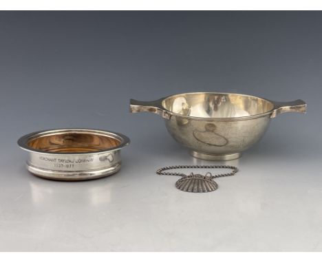 An Edwardian silver quaich, Marples &amp; Co, Sheffield 1908, 7.53ozt, an Elizabeth II silver mounted bottle coaster and a wh