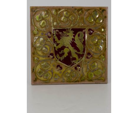 Pilkington, a Royal Lancastrian relief moulded heraldic lustre tile, painted with a red shield with lion rampant, within foli