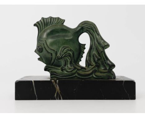 An Art Deco patinated art metal sculpture of a fish, circa 1930, modelled diving, with long flowing tail, on a marble slab ba