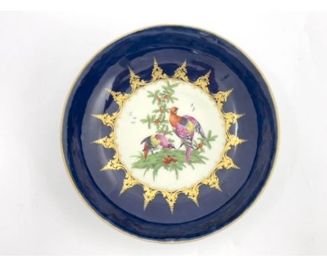 A Worcester blue ground/wet blue shallow dish, circa 1770s, decorated with fancy birds to the centre, crescent mark