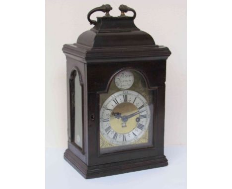 An 18th Century ebonised bracket clock with arched brass engraved dial and 4" silvered Roman chapter ring below a silvered ca