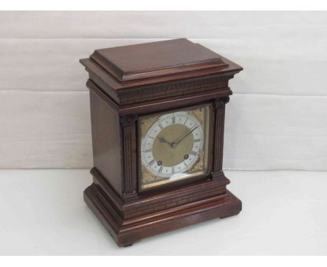 An early 20th Century mahogany bracket clock of architectural form, brass spandrelled dial with Roman silvered chapter ring, 