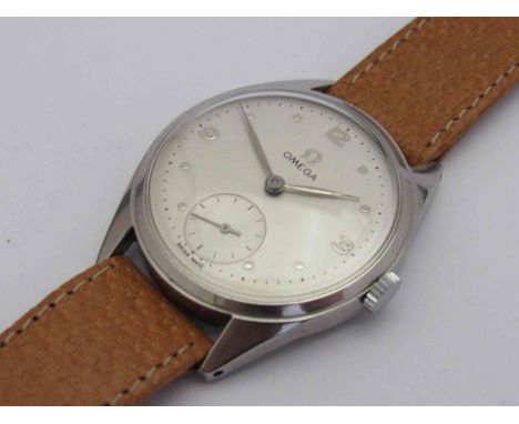 OMEGA: a manual wind gent's steel wristwatch, silvered dial with Arabic numerals, dot markers and subsidiary seconds, housed 