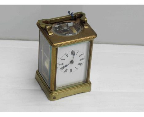 A late 19th/early 20th Century French brass carriage clock with Roman enamelled dial (hairlined), striking a coiled gong, wit