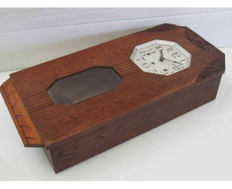 An Art Deco oak cased wall clock with octagonal silvered Arabic dial, three train movement, key and pendulum