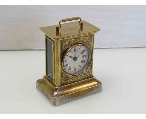An early 20th Century Junghans brass cased 8 day musical carriage clock with subsidiary seconds