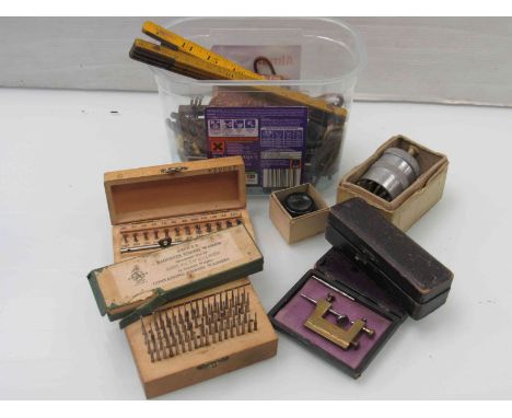 A box of watchmaker's tools including roller sinks, rules, etc