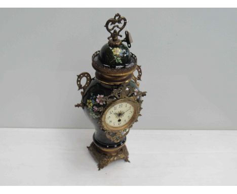 A decorative ceramic and ormulu urn form clock with 30 hour movement and key