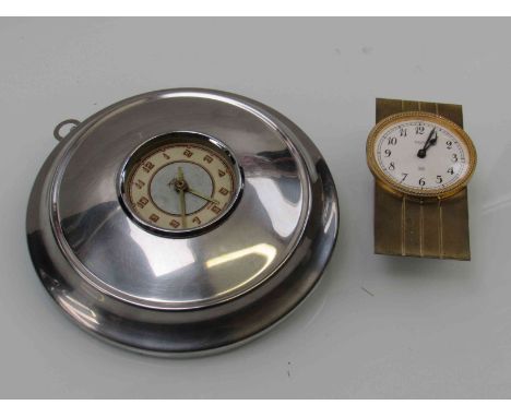 A stainless steel hub cap converted into a Smith's car clock and a brass dash quartz clock