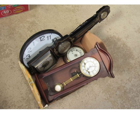 Two modem wall clocks, a carved oak barometer and a barometer/clock/thermometer 